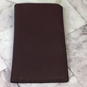 Genuine leather ox blood red passport and travel document holder.